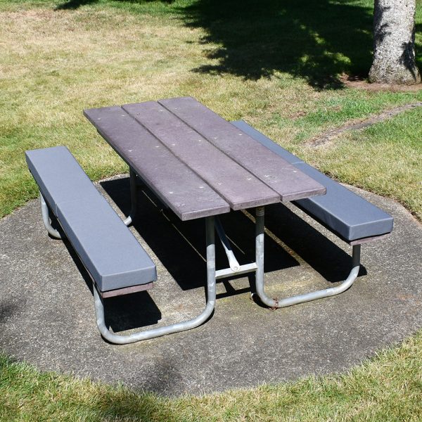 Gray bench cushions on park picnic table