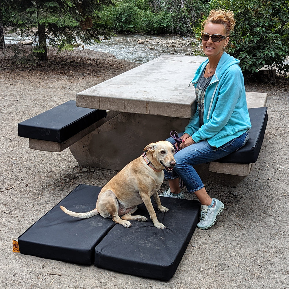Woman sitting with dog on RuffRoost dog bed