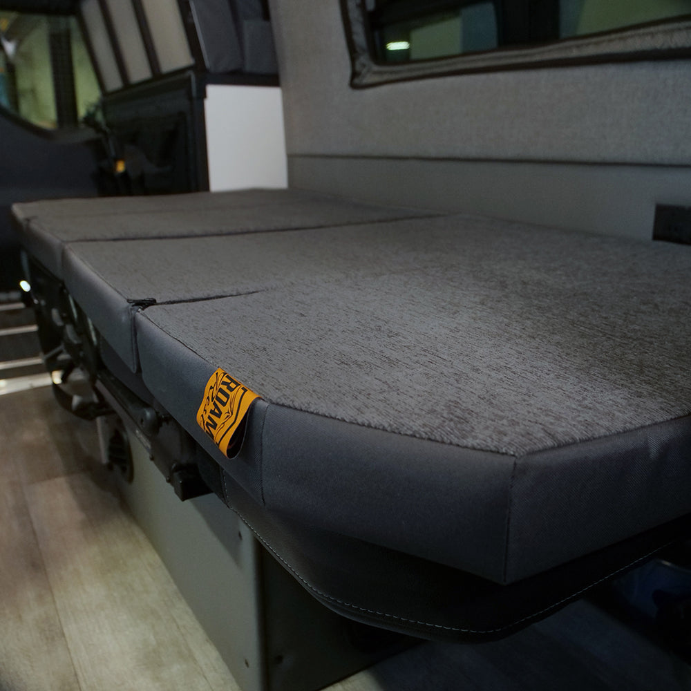 RoamRest mattress topper in laying flat sleep position on top of original Storyteller GrooveLounge