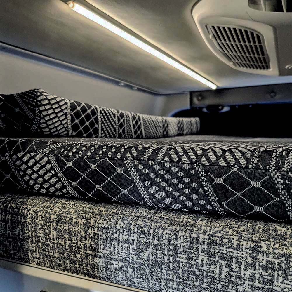 RoamRest Revel mattress topper on raised bed with folded bolsters