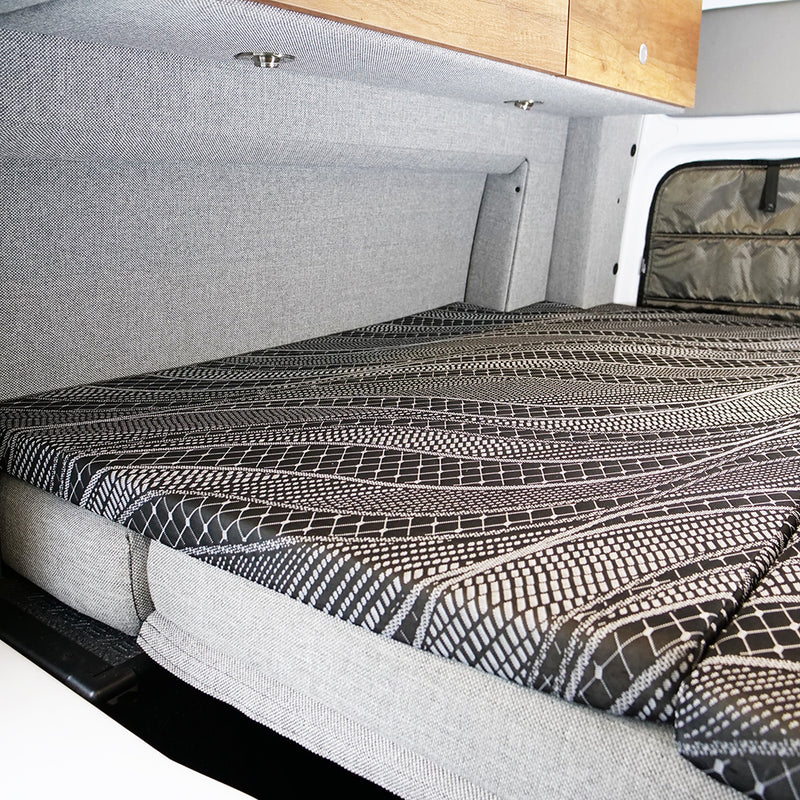 View of Storyteller mattress topper fitting on top van bed